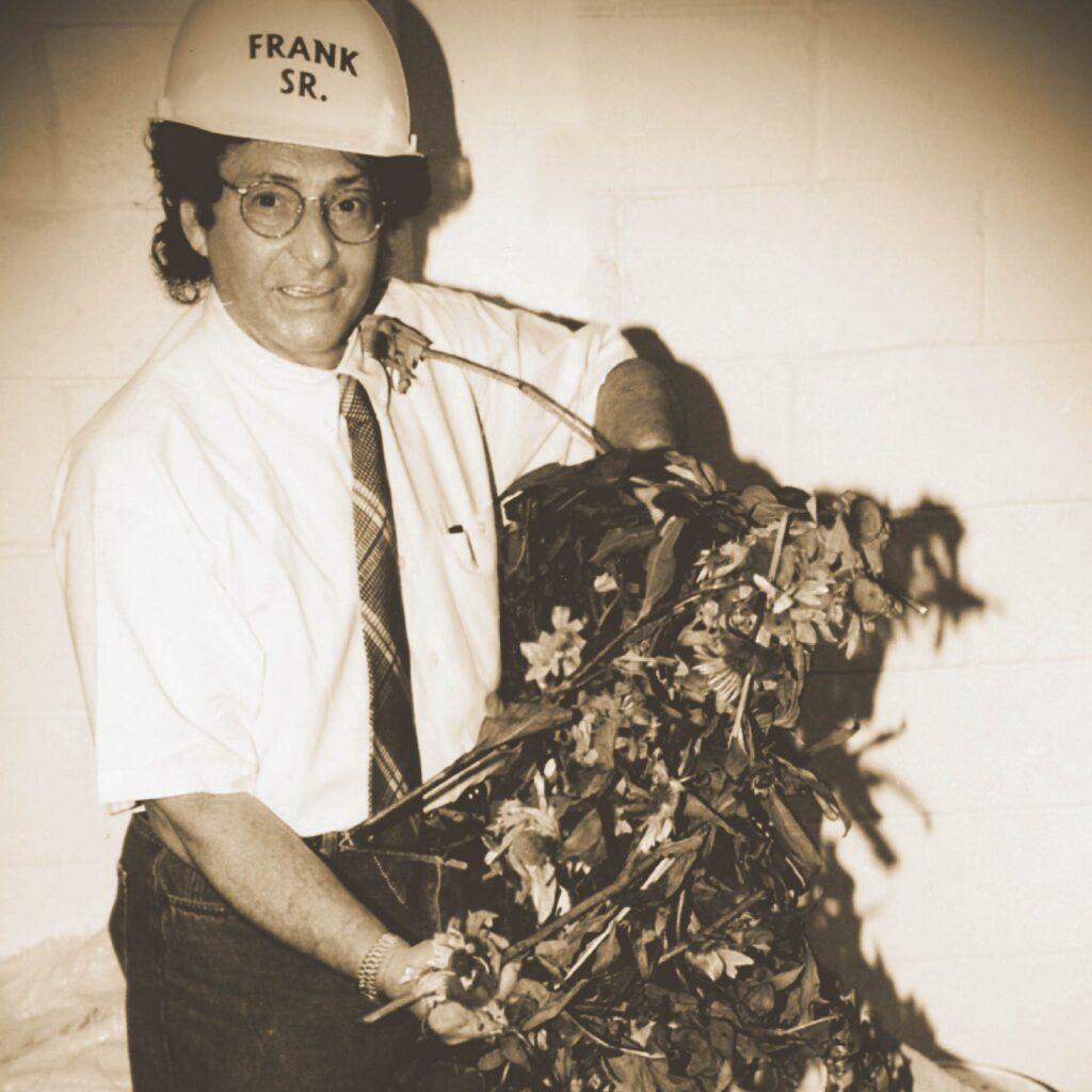 Frank D’Amelio Senior inspecting botanical herbs in manufacturing facility